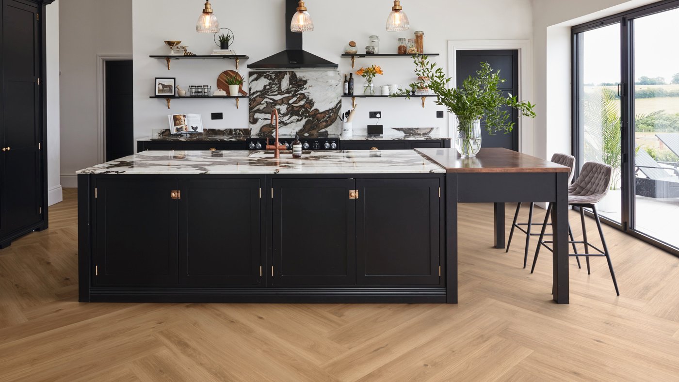 Large, black kitchen island with Golden Danish Oak LLP359 herringbone floors