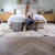 Beth Sandland bedroom laid with Karndean washed character oak wood flooring in herringbone pattern
