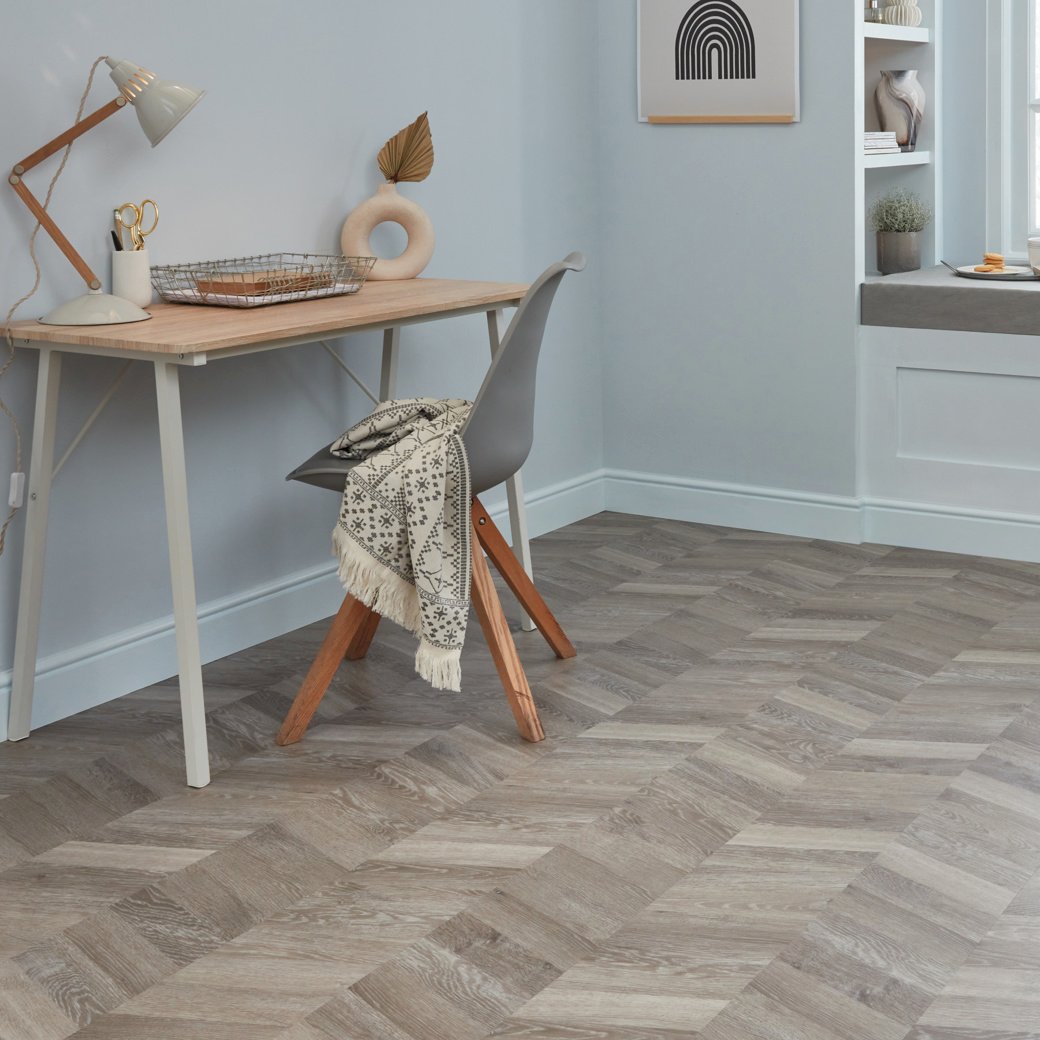 Karndean grey washed oak wood flooring laid in chevron in a home office