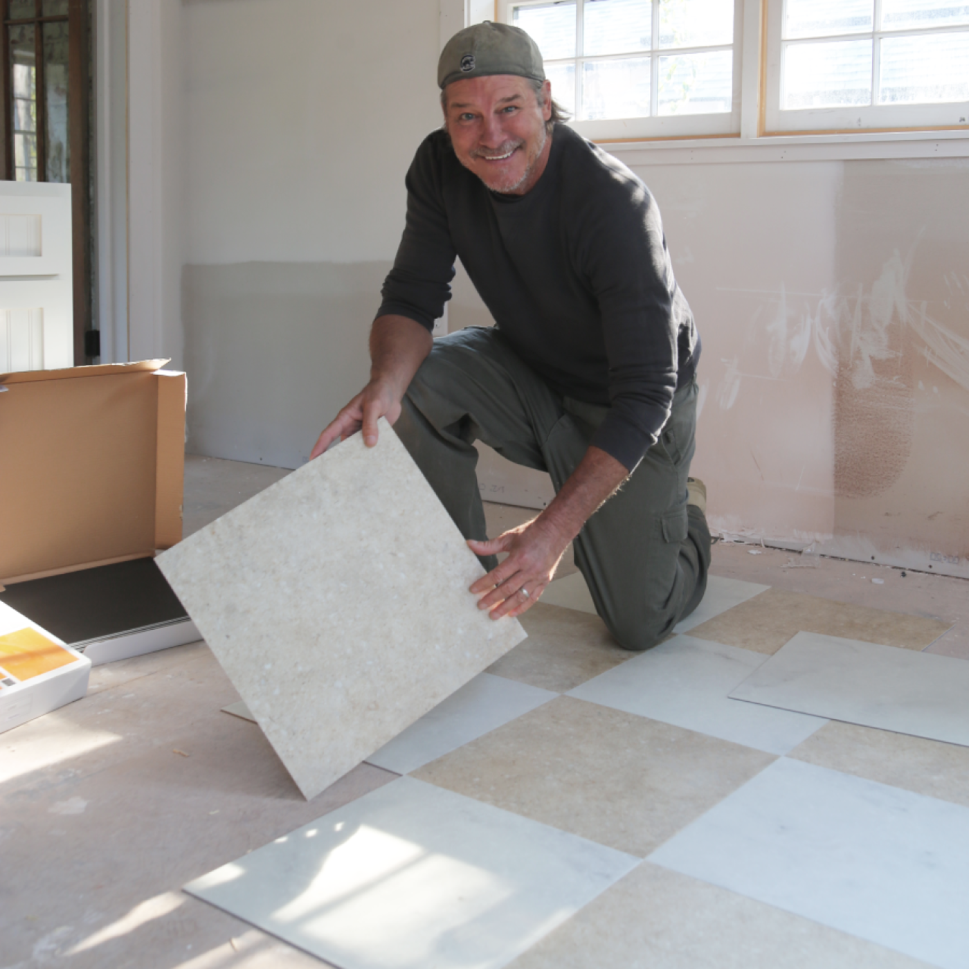 Ty Pennington installing Fiore LM16 and Piazza Limestone LST03 in a diamond pattern